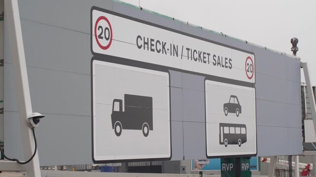 Large Overhead Signage Indicating Check-in and Ticket Sales for Vehicles at Port Terminal Entrance