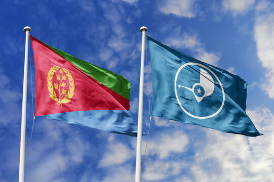 Eritrea and Yap flags waving in a clear blue sky, symbolizing a powerful diplomacy, expanding global trade, a strategic partnership, and a shared vision of unity for a sustainable future.