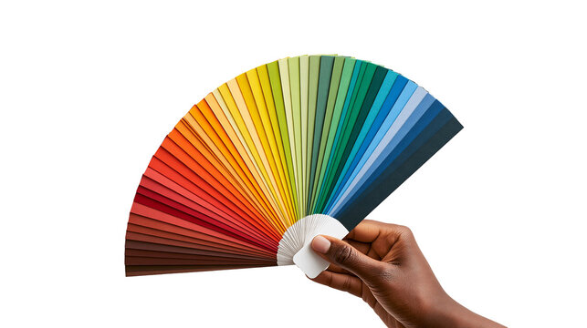 Hand holding a colorful paint color swatch fan deck with many shades