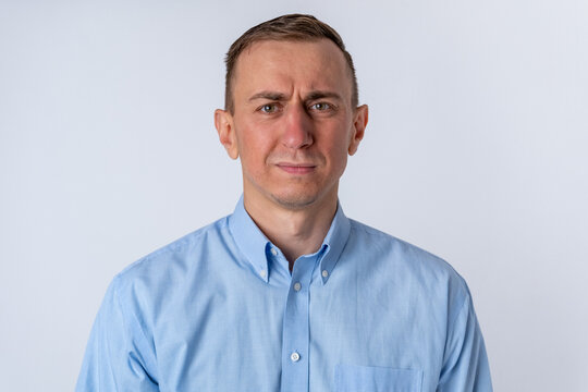 Adult man with a skeptical, disapproving expression conveying doubt, concern and frustration, professional portrait on white background suitable for business or corporate concepts