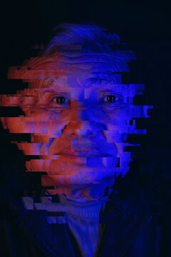 Senior man experiences virtual reality in dark cyberspace