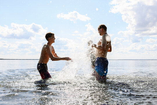 Family splashes water while swimming in the sea on the weekend