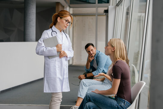 Doctor consulting patient and explaining healthcare indoors