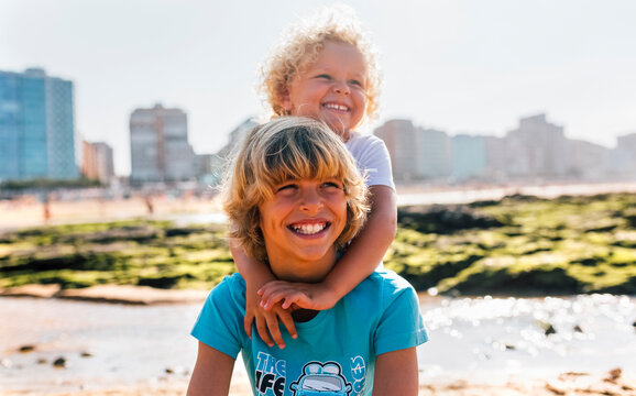 Portrait of two happy brothers on the beach