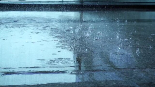 Heavy Rain Splashing on Wet Pavement Surface