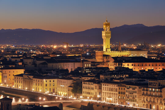 Illuminated Palazzo Vecchio dominates the Florence skyline at dusk