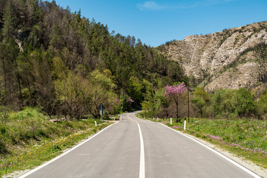 An empty road crosses the summer mountain in Saranda Albania