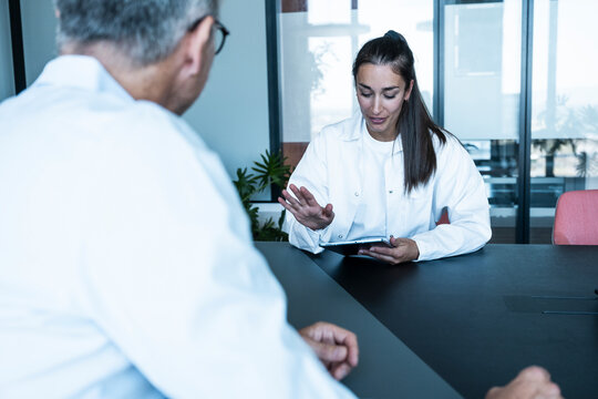 Female doctor advises patient with tablet at the indoor practice