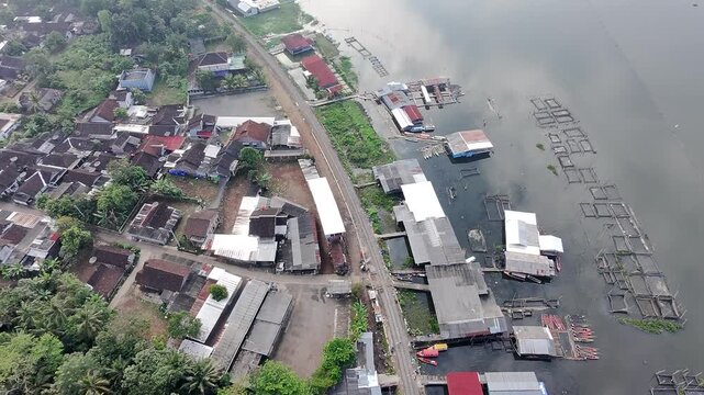 Beautiful aerial drone view of the Blue Bridge (Jembatan Biru Sumurup) at Rawa Pening lake with local village houses in Semarang, Central Java, Indonesia.