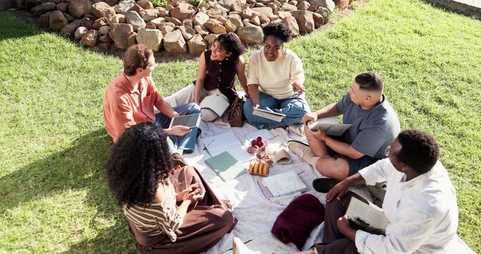 Outdoor, books and students on grass for study group, learning and talking for exam prep together. University, campus and friends with textbooks, chat and break for education, assignment and college
