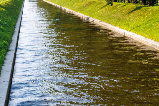 Clear water flows gently through a canal