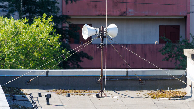 Outdoor loudspeakers mounted on a metal pole