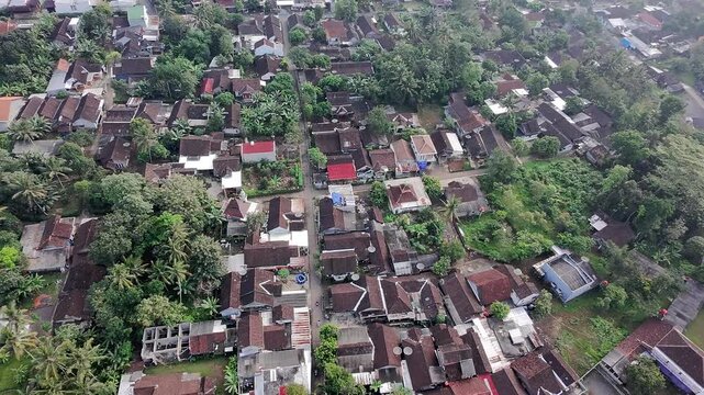 Beautiful aerial drone view of the Blue Bridge (Jembatan Biru Sumurup) at Rawa Pening lake with local village houses in Semarang, Central Java, Indonesia.