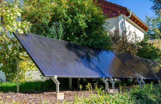 solar panels in a garden on the single-family house