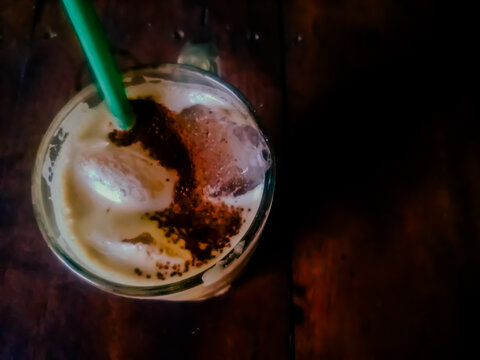 Close up of iced capuccino coffee with dark color background wood table.