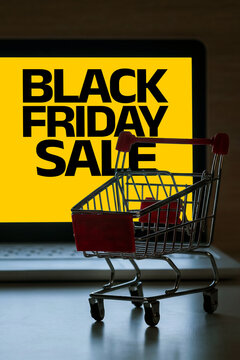 Black Friday sale with a shopping cart and a computer screen displaying the ad