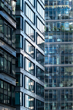 Modern buildings fill the frame with glass windows and facade geometry creating a dense urban architecture pattern across the buildings