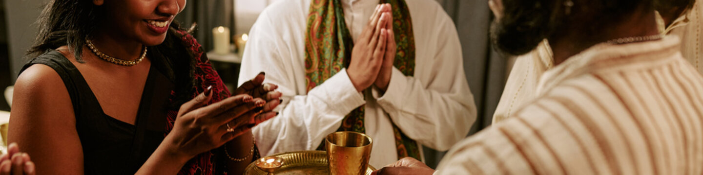 Header of Indian family celebrating festival of lights with traditional prayer rituals and oil lamps. Concept represents cultural celebration suitable for holiday marketing campaigns