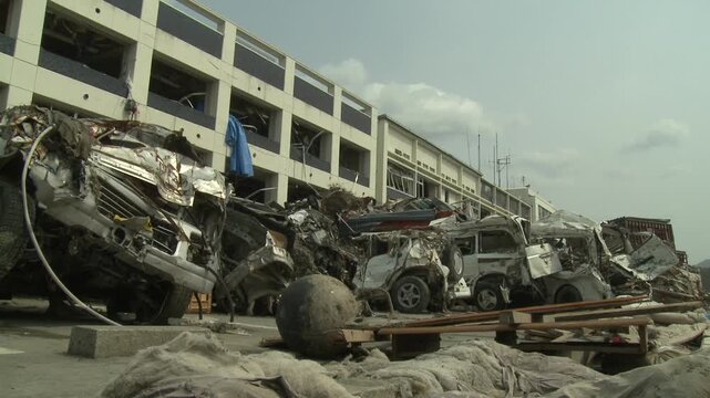 Destroyed Car Lie Crumpled Outside Wrecked Building In Aftermath Of Tsunami In Japan