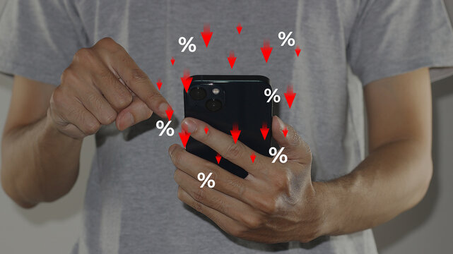 Show percentage, special offer of shopping department store discount and tax concept, adjusting interest rates on a smartphone screen with falling percentage symbols and red arrows pointing down