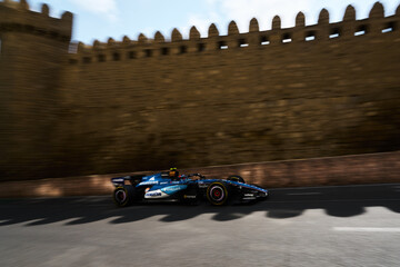 Obraz premium BAKU, AZERBAIJAN - SEPTEMBER 2026: Williams Racing F1 car speeds past the medieval stone walls of the Old City during the Formula 1 Azerbaijan Grand Prix 2026