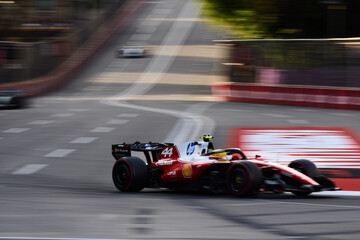 Naklejka premium BAKU, AZERBAIJAN - SEPTEMBER 2026: Lewis Hamilton drives the Scuderia Ferrari F1 car at high speed along Baku City Circuit during Formula 1 Azerbaijan GP 2026