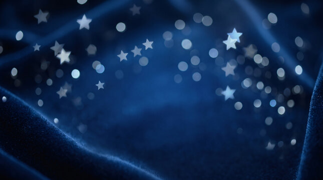 Abstract dark blue velvet background with glowing silver star bokeh and glittering lights