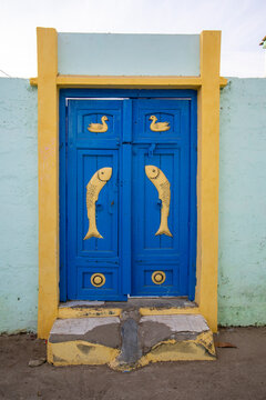 Blue door with carved yellow fish, Mandvi, India