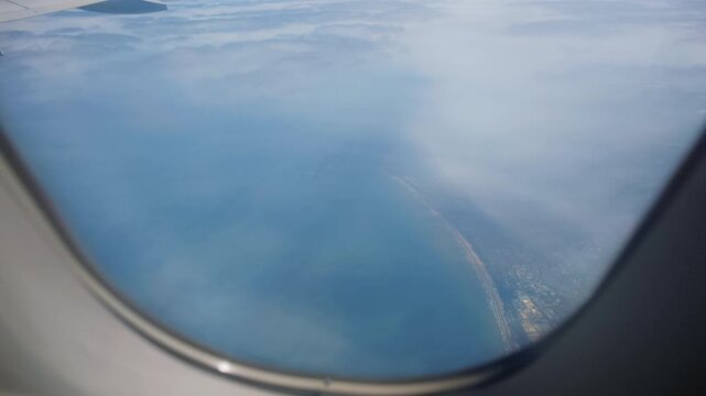 Aerial landscape viewed through airplane window