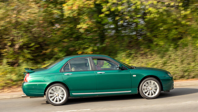 Milton Keynes; UK - Sept. 27th 2026: 2006 green MG zt 260 V8 classic car driving on a British road