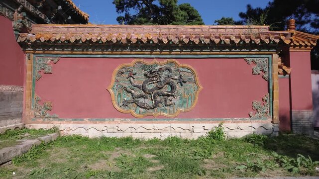 Traditional red wall with dragon relief at Zhaoling Tomb