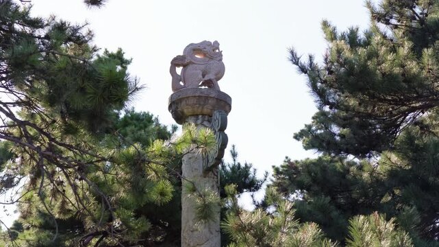 Carved huabiao ceremonial column among pine trees at Zhaoling Tomb