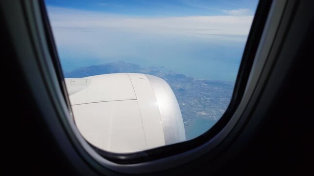 Airplane engine and sky seen from passenger window