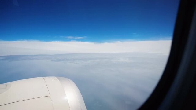 Clouds and distant landscape seen from airplane window