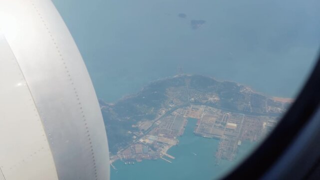 Aerial view of land and clouds from aircraft