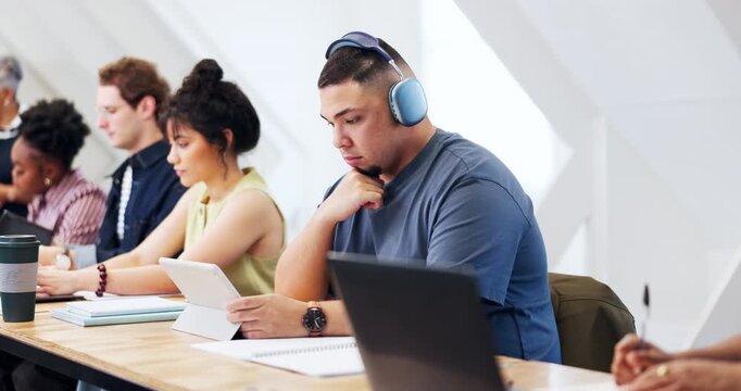 Tablet, education and programmer with man in classroom for tech workshop, research and learning. App development, ai training model and software review with person and headphones for project