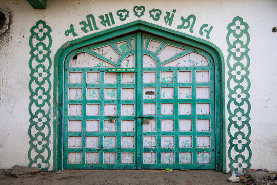Ornate green wooden door, Mandvi, India