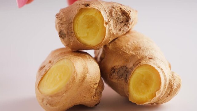 Fresh ginger root close-up on white background. Organic spice and healthy cooking ingredient.
