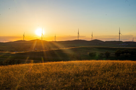 Wind Turbines Bathed in Golden Sunset Glow.