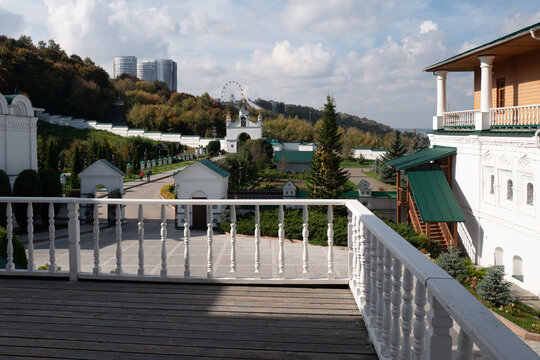 View From Monastery Balcony Over Courtyard Garden Toward Ferris Wheel and Autumn Hills. Pechersky Monastery in Nizhny Novgorod, Russia.