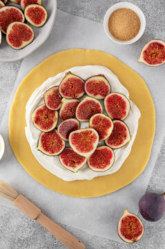 The process of making a galette with cream cheese filling and fresh figs. Step by step recipe. Top view.