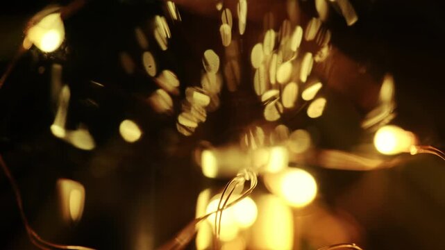 Extreme close-up shot of a glowing light bulb with warm golden bokeh, textured glass, and soft ambient illumination.