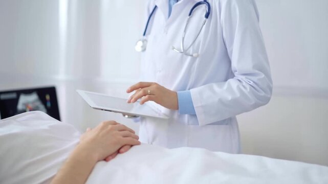 Doctor consulting patient with digital tablet in hospital room. Healthcare professional providing care