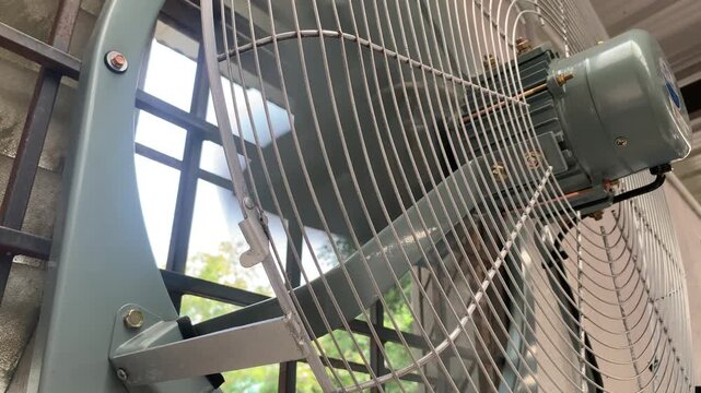 close-up of a rapidly spinning industrial exhaust fan