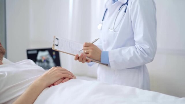 Female doctor writing medical report of patient lying in bed in hospital