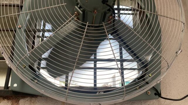 rear view of an industrial exhaust fan spinning rapidly