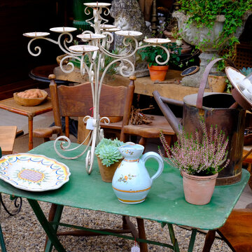 Vintage outdoor table with candelabra and pottery