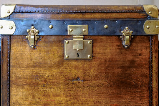 Antique wooden trunk with brass hardware close-up