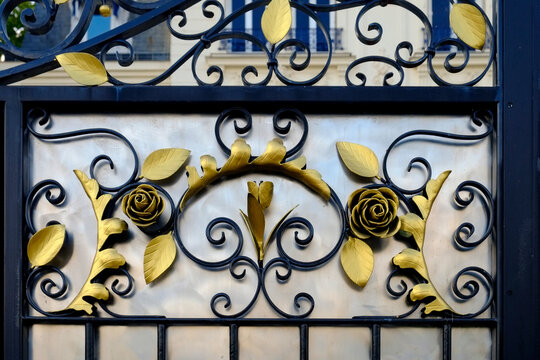 Wrought iron gate detail with gold rose motif