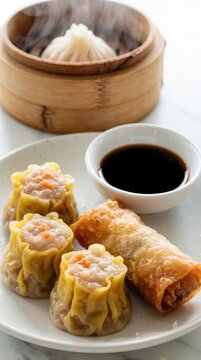 Assorted Asian dim sum served on white plate. Steamed siu mai dumplings, crispy spring roll with soy sauce dip. Hot bao bun in bamboo steamer with steam rising. Delicious Chinese food appetizers for